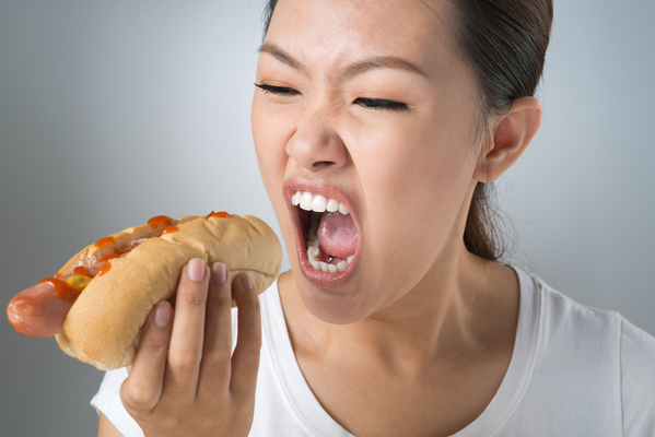 Young woman is about to devour a hot dog