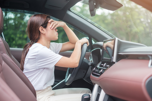 woman feeling stress and angry during drive car long time. Asian girl tired and fatigue having headache stop after driving car in traffic jam. 