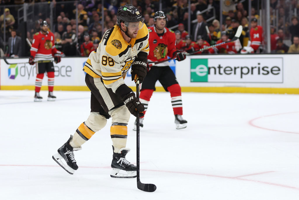David Pastrnak #88 of the Boston Bruins takes a shot against the Chicago Blackhawks during the third period of the Bruins home opener at TD Garden on October 11, 2023.