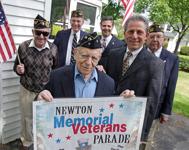 Newton Veterans holding parade sign