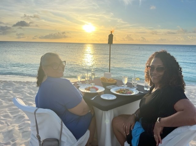 Pebbles and her friend Sara having dinner on the beach