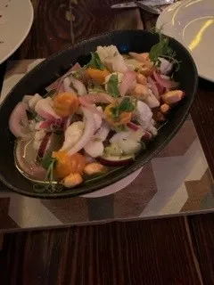Bowl of ceviche with onions and almonds