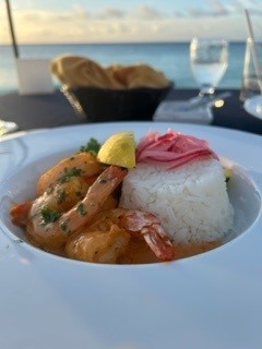 Plate of shrimp with a coconut curry sauce and white rice