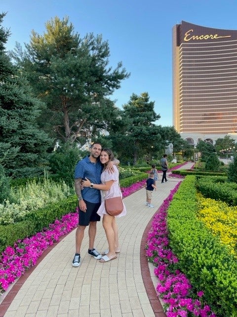 Picture of Ramiro and his wife Nicole on the path leading to the Encore Casino in the background