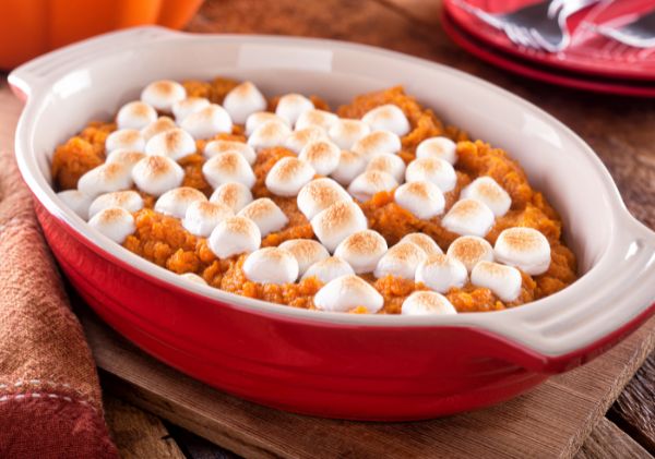 Oval casserole dish with sweet potato and marshmallows