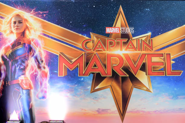 Brie Larson as Captain Marvel in front of a Captain Marvel background