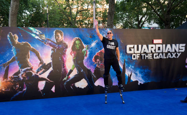 Vin Diesel wearing an I Am Groot shirt in front of a Guardian's of the Galaxy background