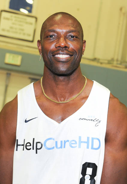 Picture of Terrell Owens wearing a white jersey that says Help Cure HD
