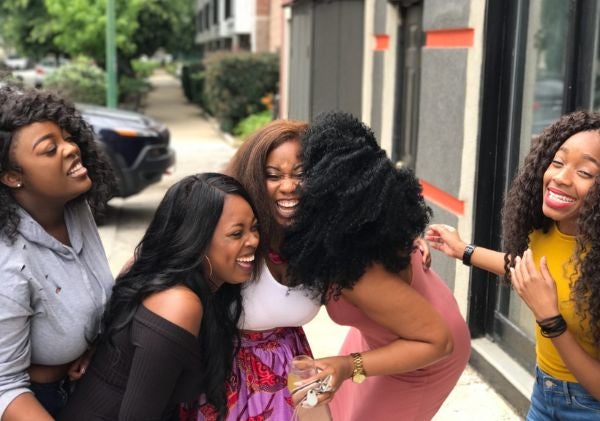 Group of four black women laughing