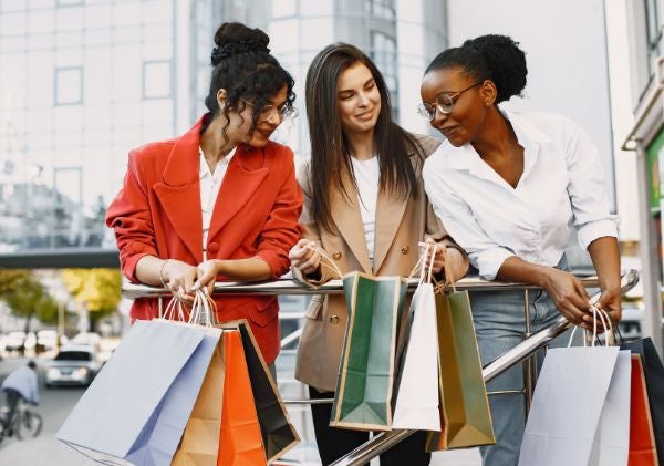 Three woman holding shopping bags