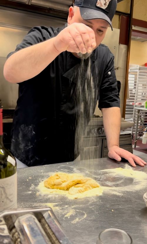 Chef Jason sprinkles flour on some pasta dough