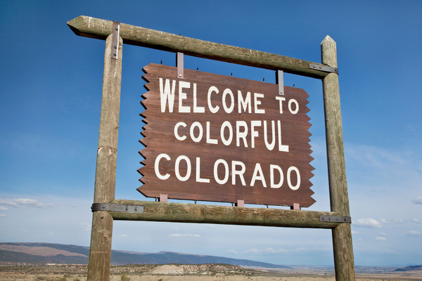 Wood sign that reads Welcome to Colorful Colorado