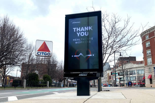 View of Kenmore Square with a Thank You digital sign in the foreground and the famous Citgo sign in the background